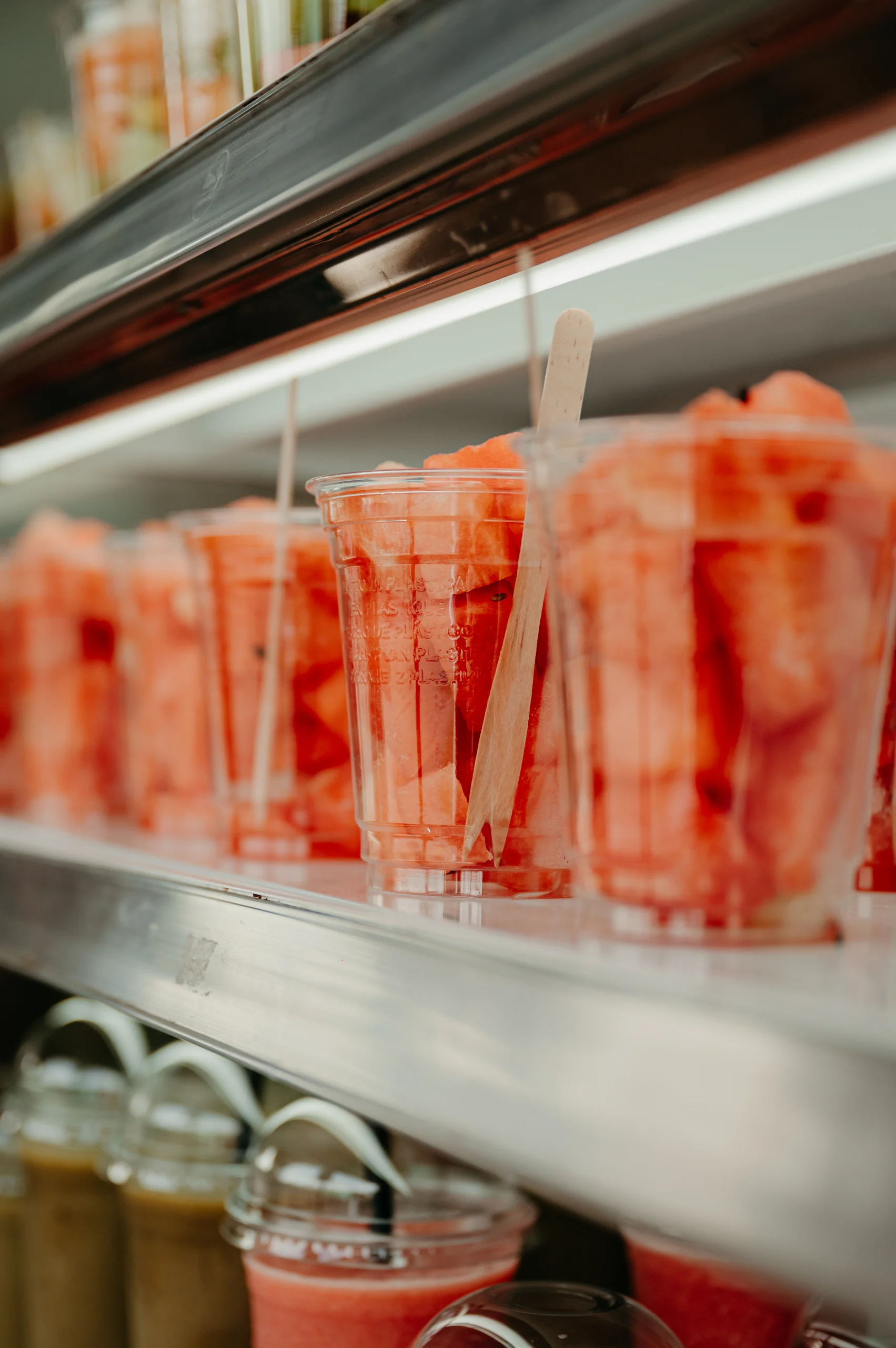 Bekers met vers gesneden fruit in de koeling